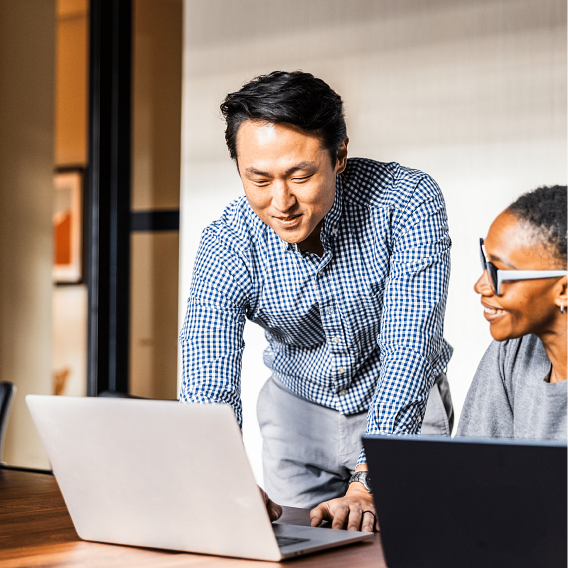 Two colleagues working closely together in the office